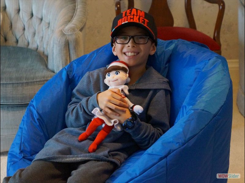 Connor with Jingles Sitting in the Blue Chair